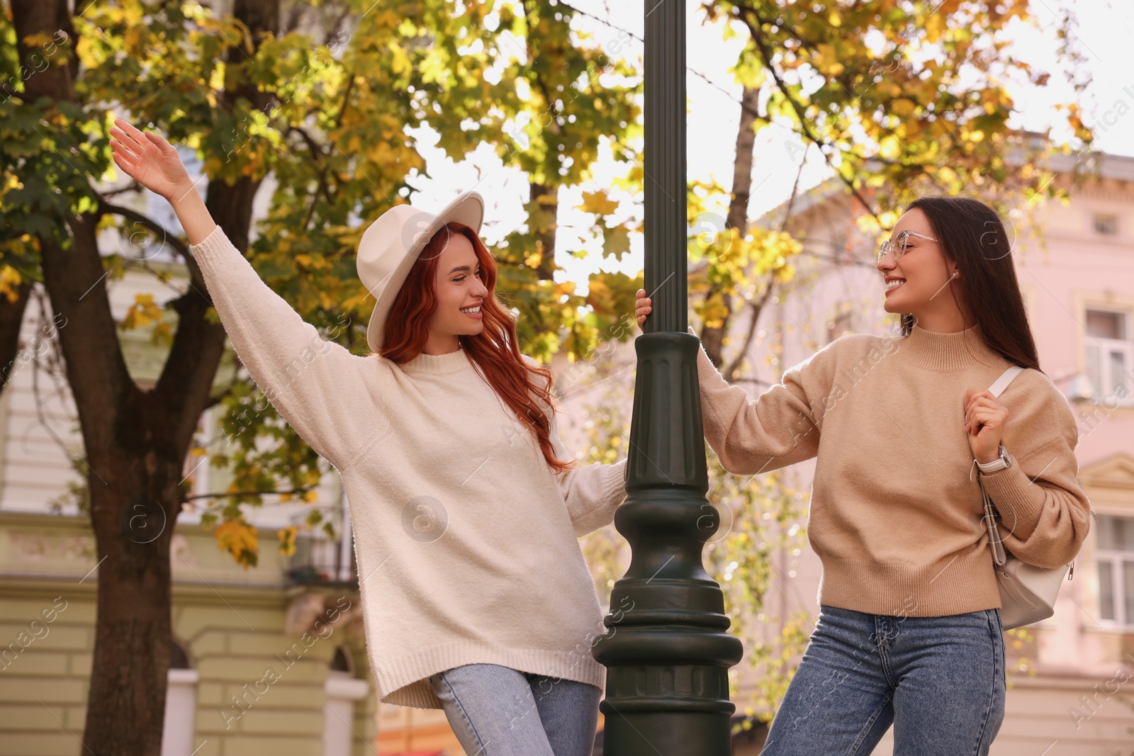 Photo of Happy friends having fun outdoors on autumn day