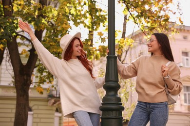 Photo of Happy friends having fun outdoors on autumn day
