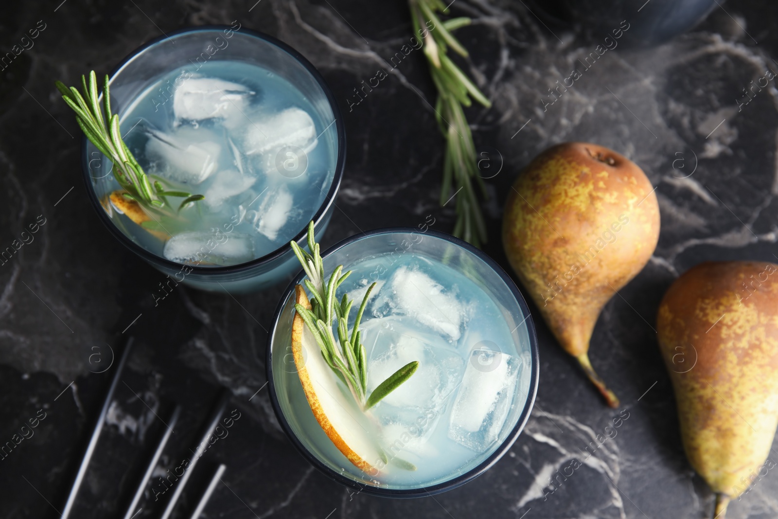 Photo of Flat lay composition with glasses of pear and rosemary cocktail on dark table