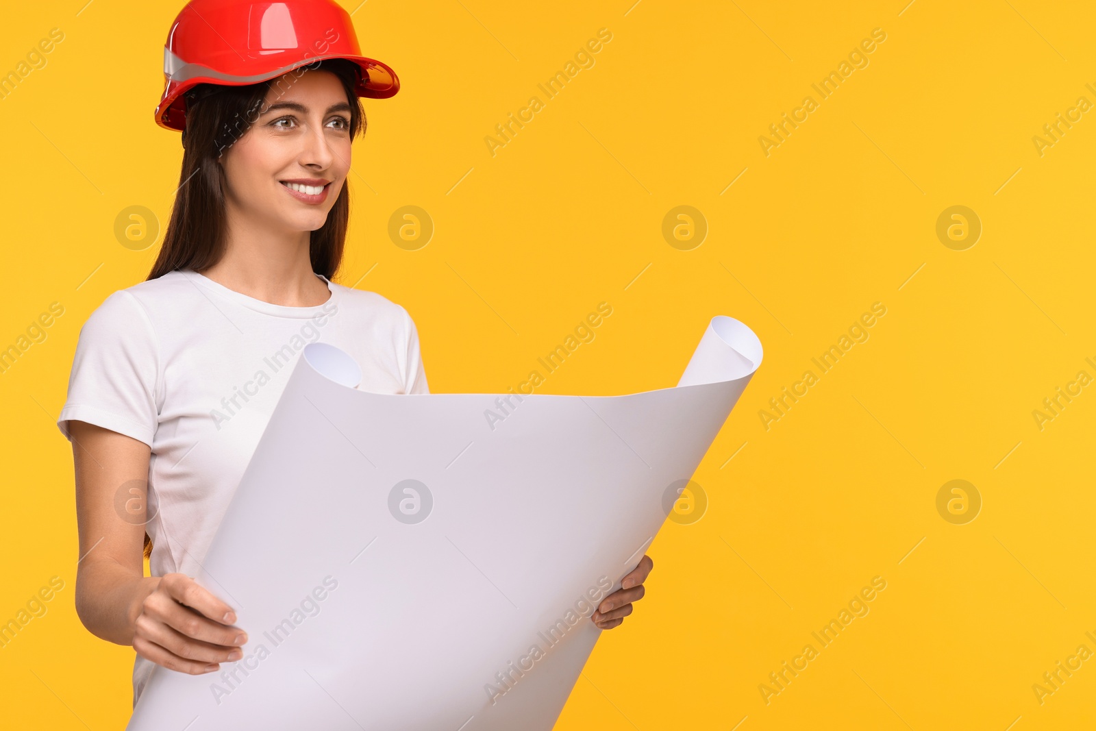 Photo of Architect in hard hat with draft on yellow background, space for text