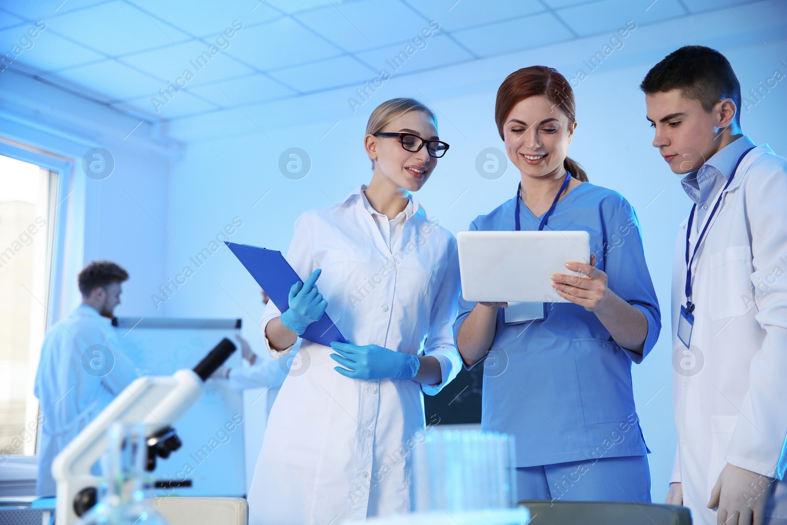 Photo of Group of scientists working in modern chemistry laboratory