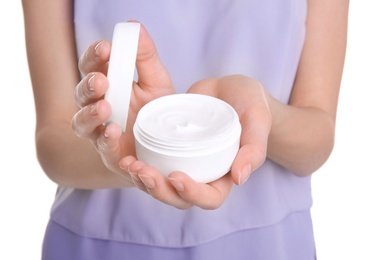 Young woman holding jar with hand cream, closeup