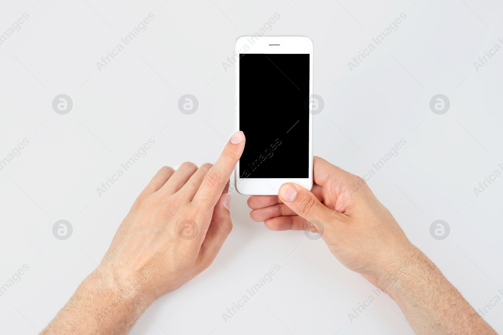 Photo of Young man holding mobile phone with blank screen in hand on white background