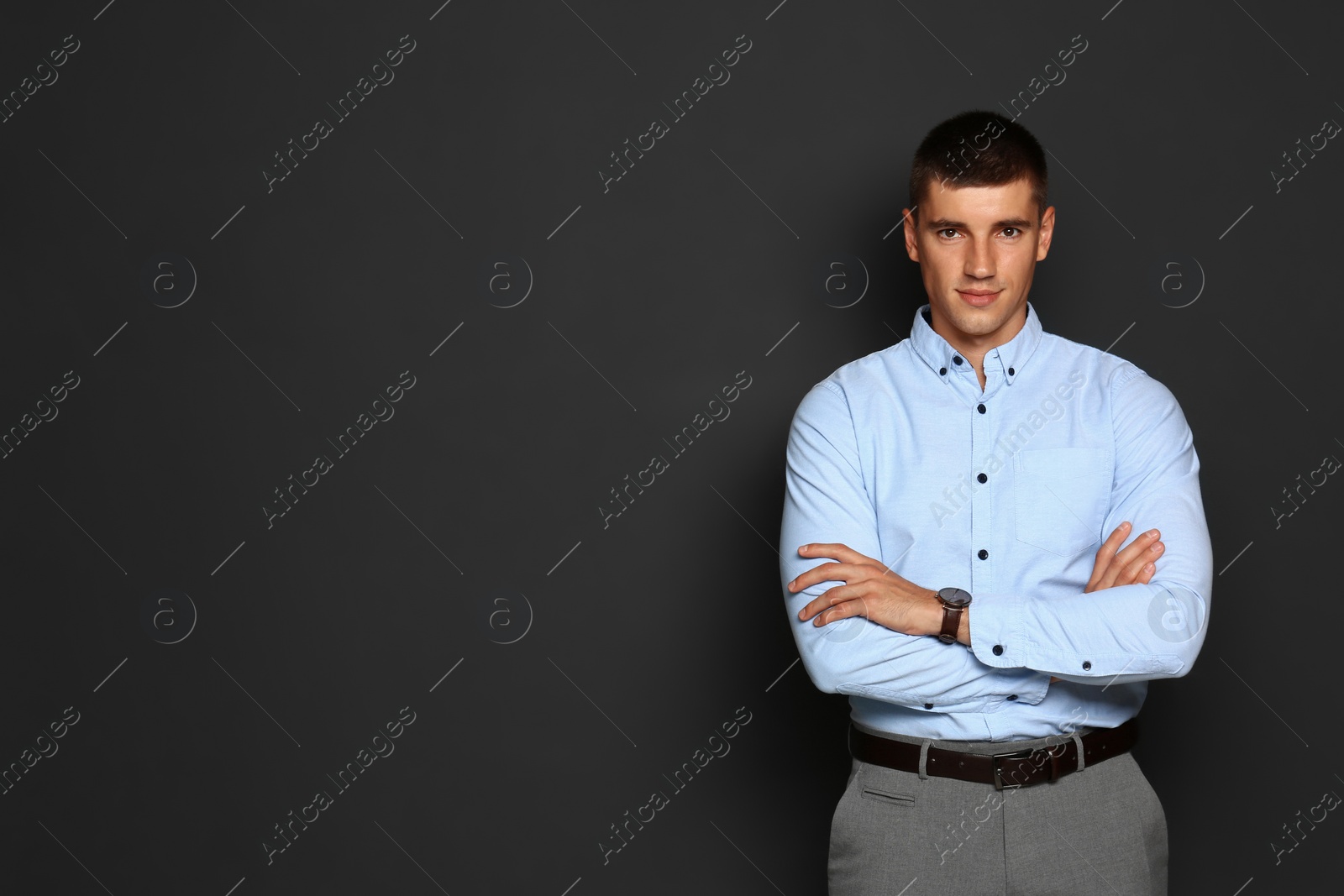 Photo of Portrait of handsome young man on dark background. Space for text