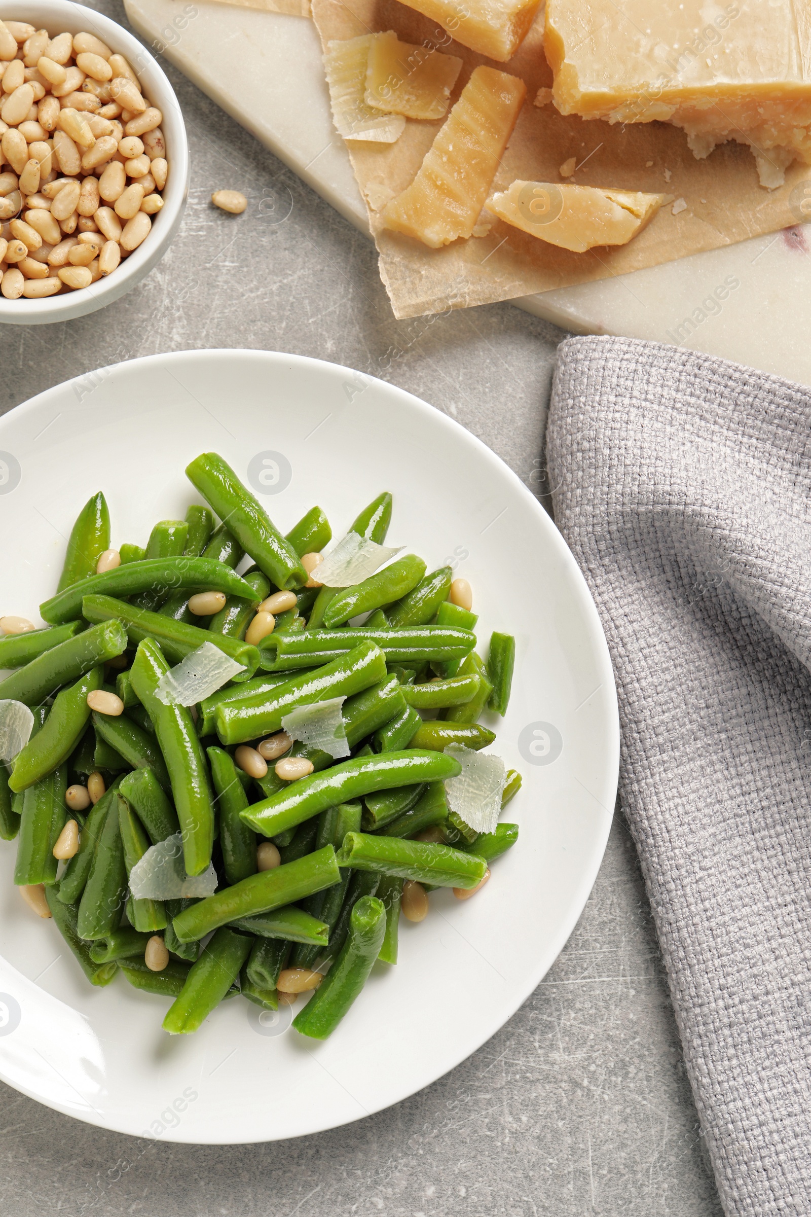 Photo of Tasty salad with green beans served on light grey table, flat lay