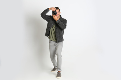 Photo of Professional photographer working on white background in studio