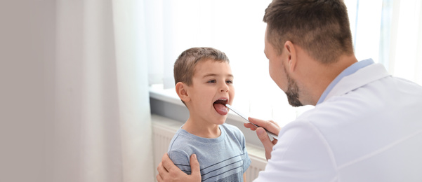 Image of Doctor examining little patient in clinic, space for text. Banner design