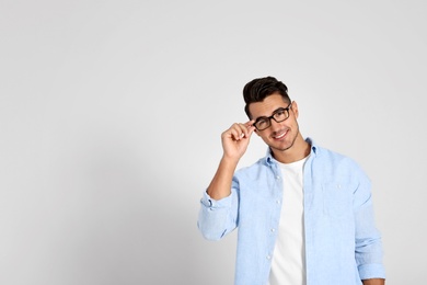 Portrait of handsome young man and space for text on white background