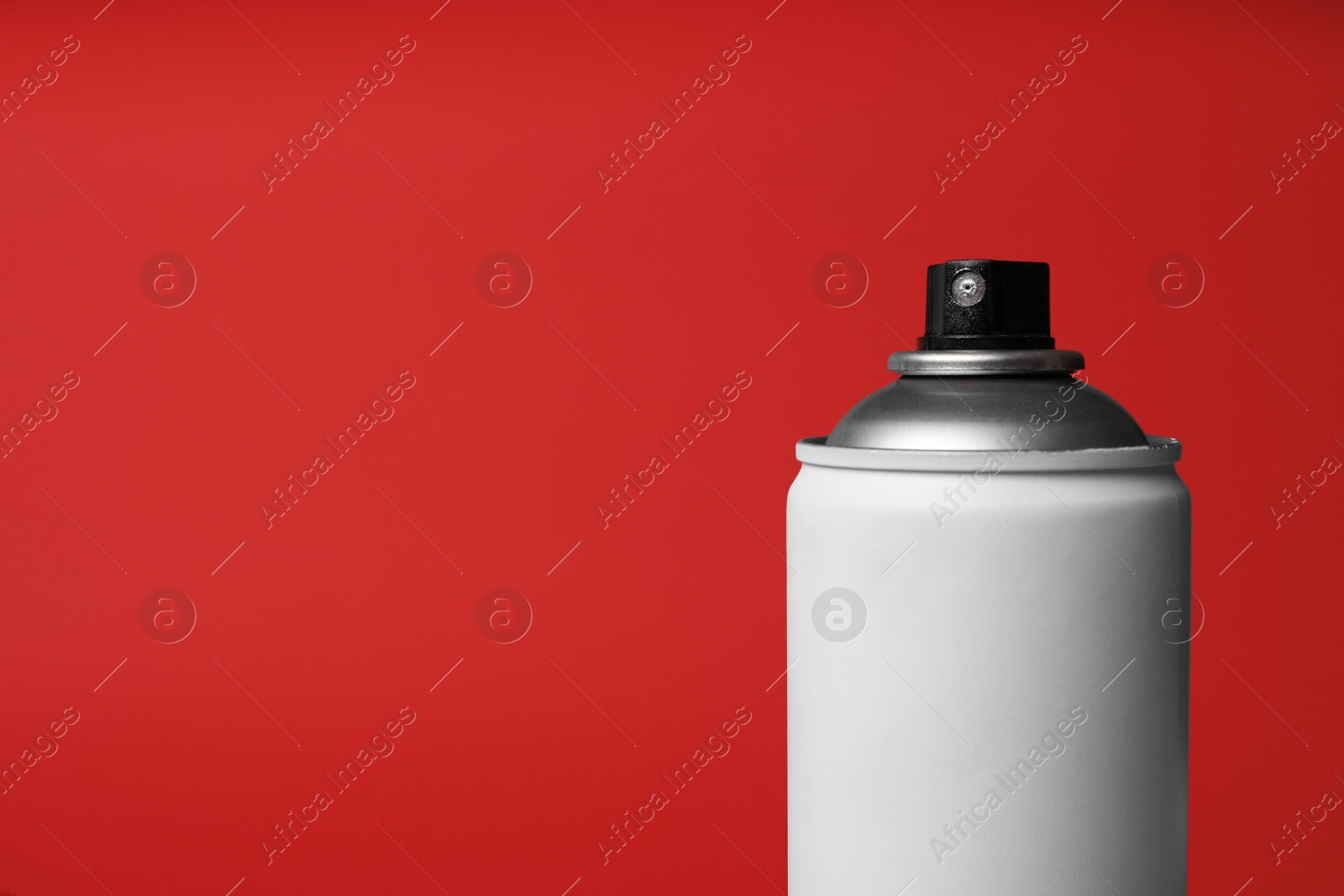 Photo of Can of spray paint on red background, closeup with space for text. Graffiti supply
