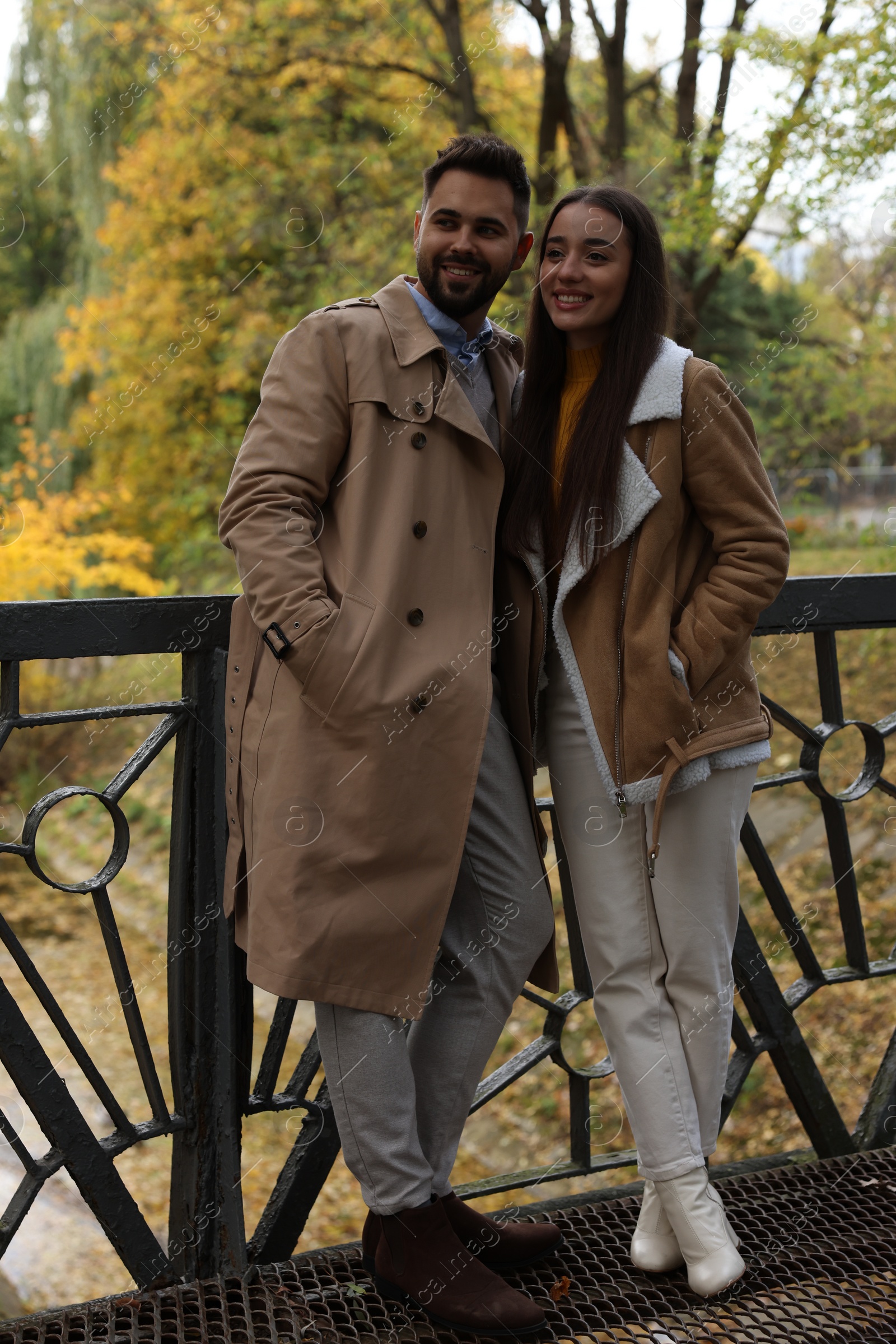 Photo of Happy young couple spending time together in autumn park