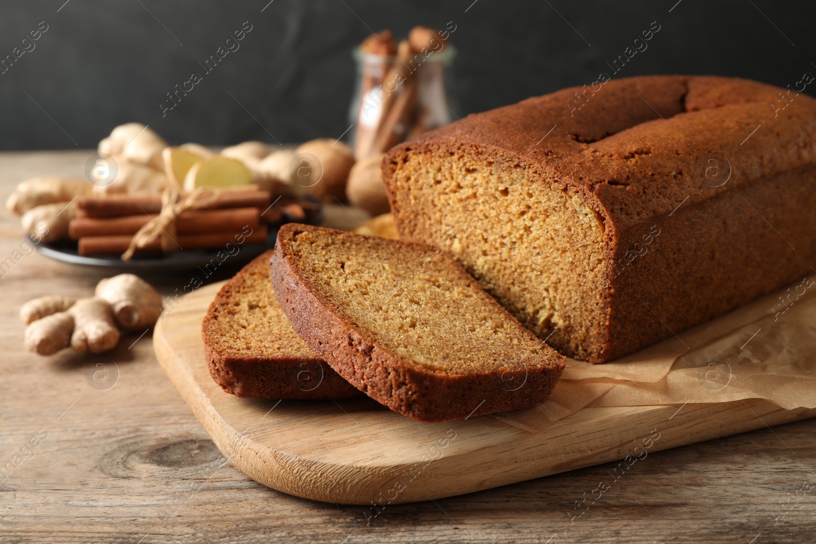 Photo of Fresh sliced gingerbread cake on wooden table