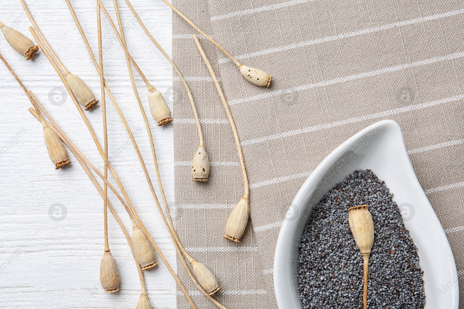 Photo of Flat lay composition with poppy seeds on wooden background