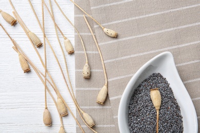 Flat lay composition with poppy seeds on wooden background