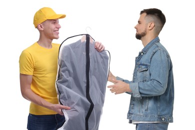 Dry-cleaning delivery. Courier giving garment cover with clothes to man on white background