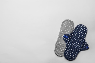 Photo of Reusable cloth menstrual pads on white background, flat lay. Space for text