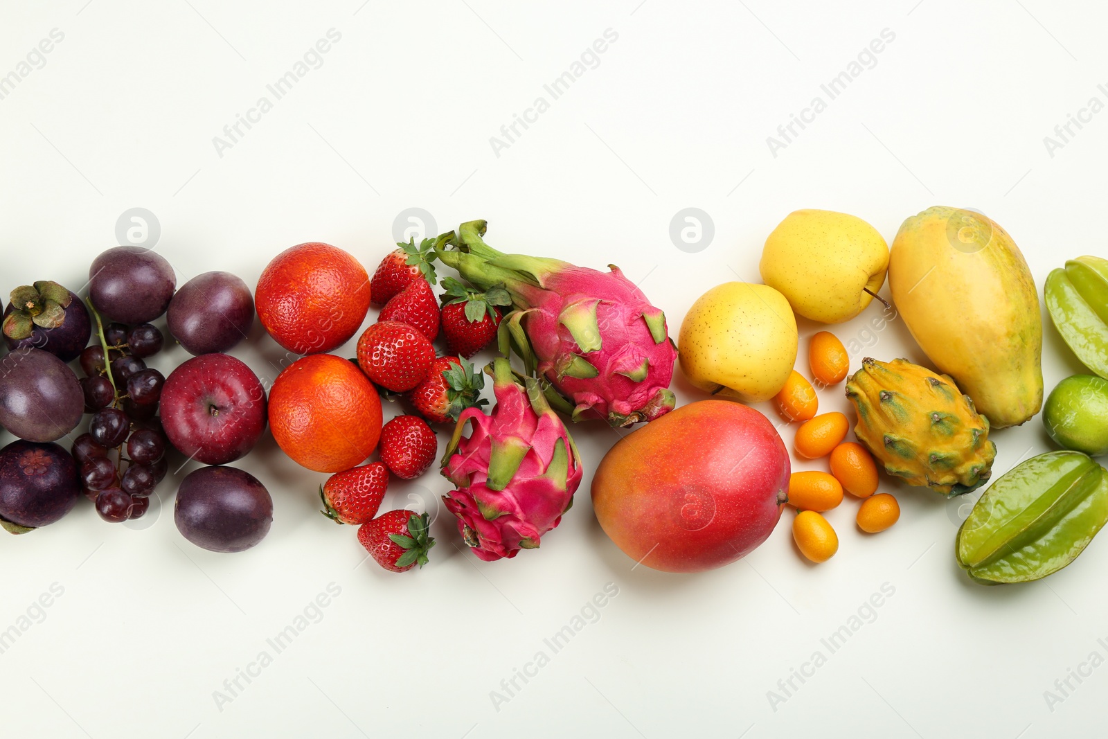 Photo of Assortment of fresh exotic fruits on white background, flat lay