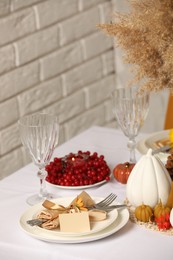 Photo of Beautiful autumn place setting and decor for festive dinner on table indoors