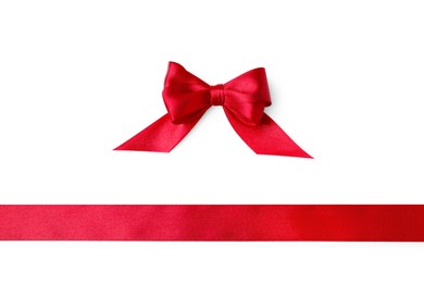 Photo of Red satin ribbon and bow on white background, top view