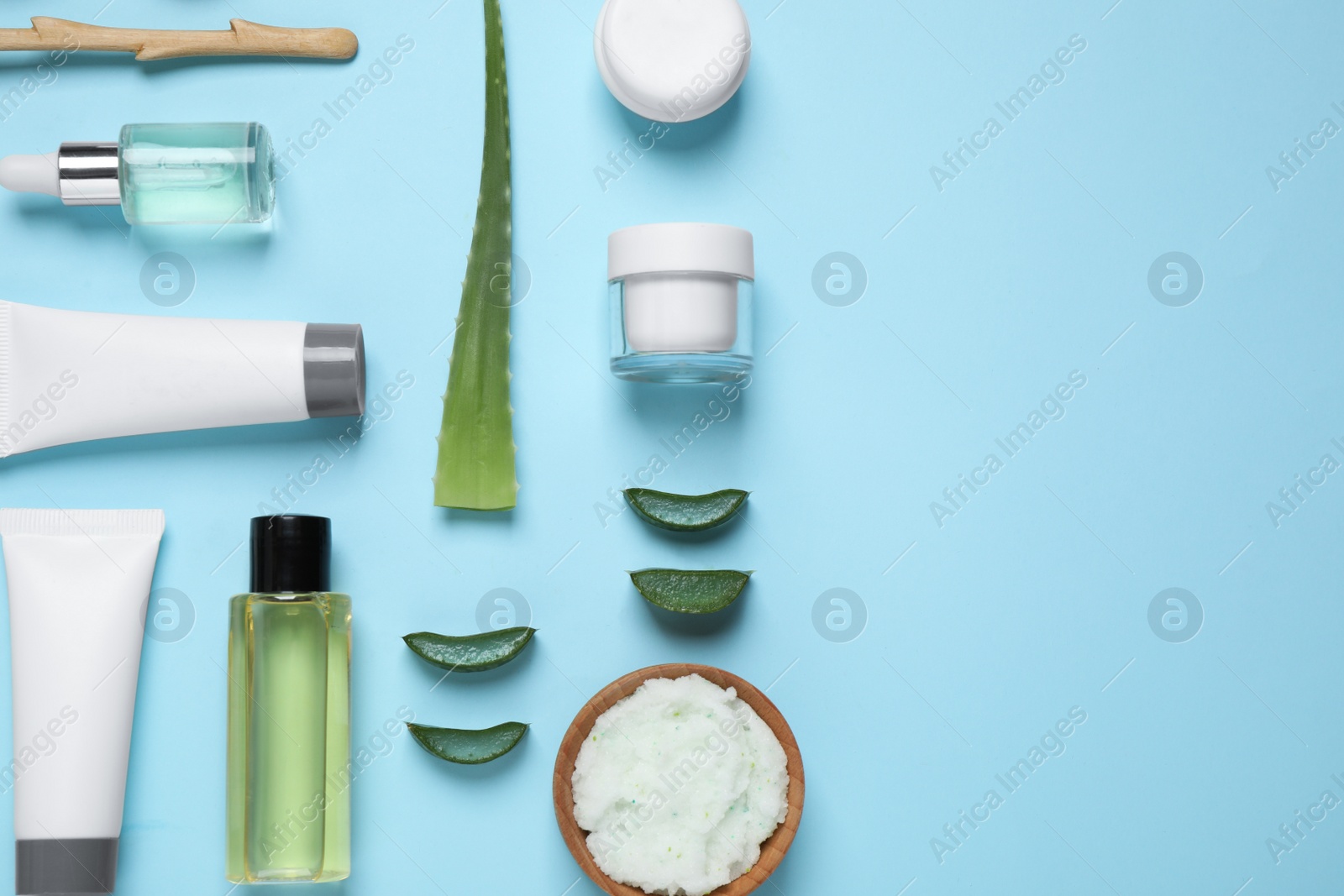 Photo of Flat lay composition with aloe vera and cosmetic products on light blue background. Space for text