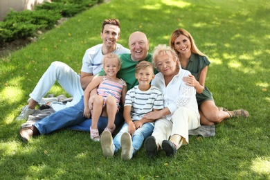 Photo of Couple with children and elderly parents in park