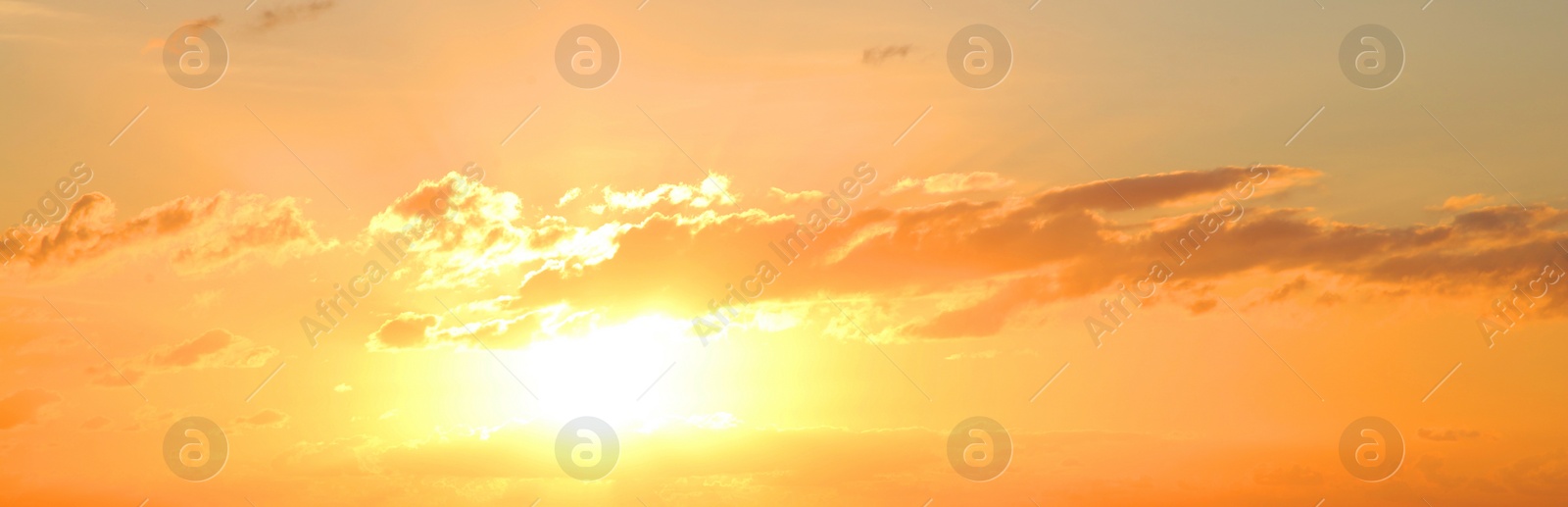 Image of Sun shining on beautiful cloudy sky at sunset, banner design