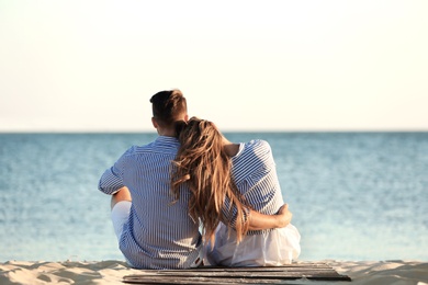 Happy young couple resting together on beach