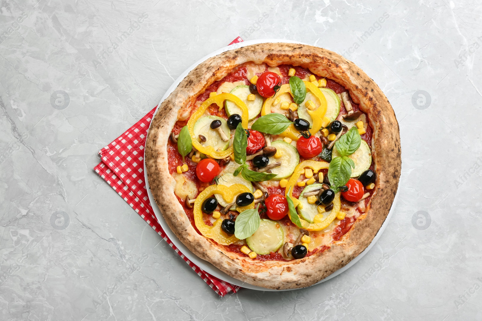 Photo of Tasty vegetable pizza on light grey table, top view