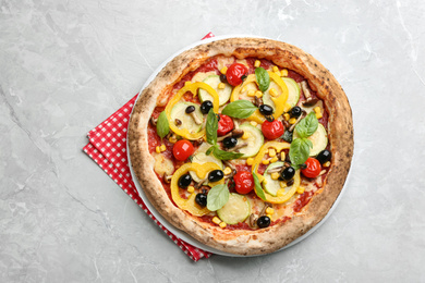 Tasty vegetable pizza on light grey table, top view