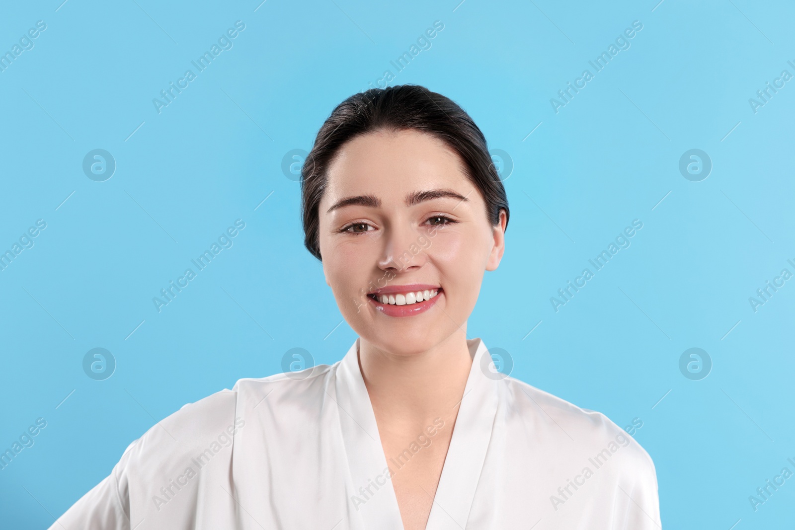 Photo of Portrait of attractive young woman with smooth skin on turquoise background