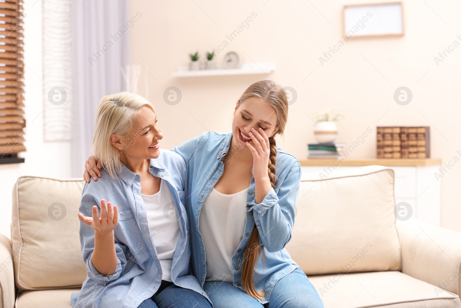 Photo of Mother and her adult daughter spending time together at home