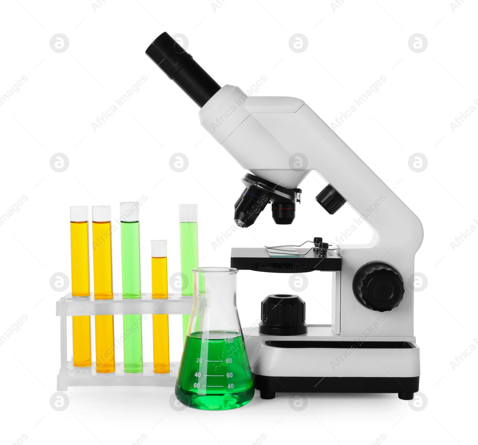 Photo of Laboratory glassware with colorful liquids and microscope isolated on white