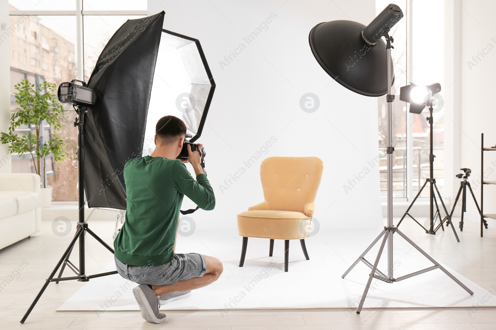 Photo of Young photographer working in professional studio