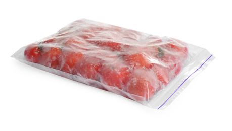 Photo of Frozen tomatoes in plastic bag isolated on white. Vegetable preservation
