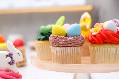 Photo of Tasty decorated Easter cupcakes on table, closeup