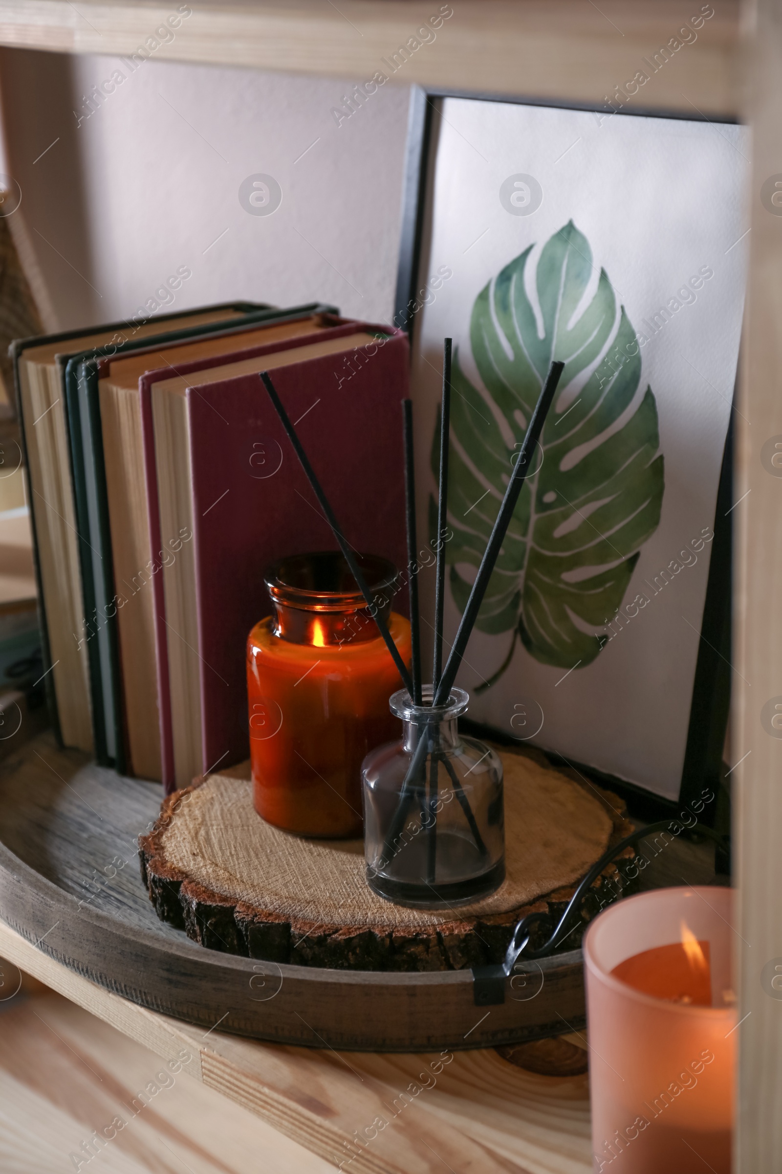 Photo of Stylish tray with different interior elements on wooden shelf