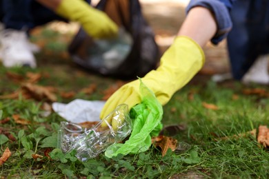 Photo of Woman collecting garbage in park, closeup view