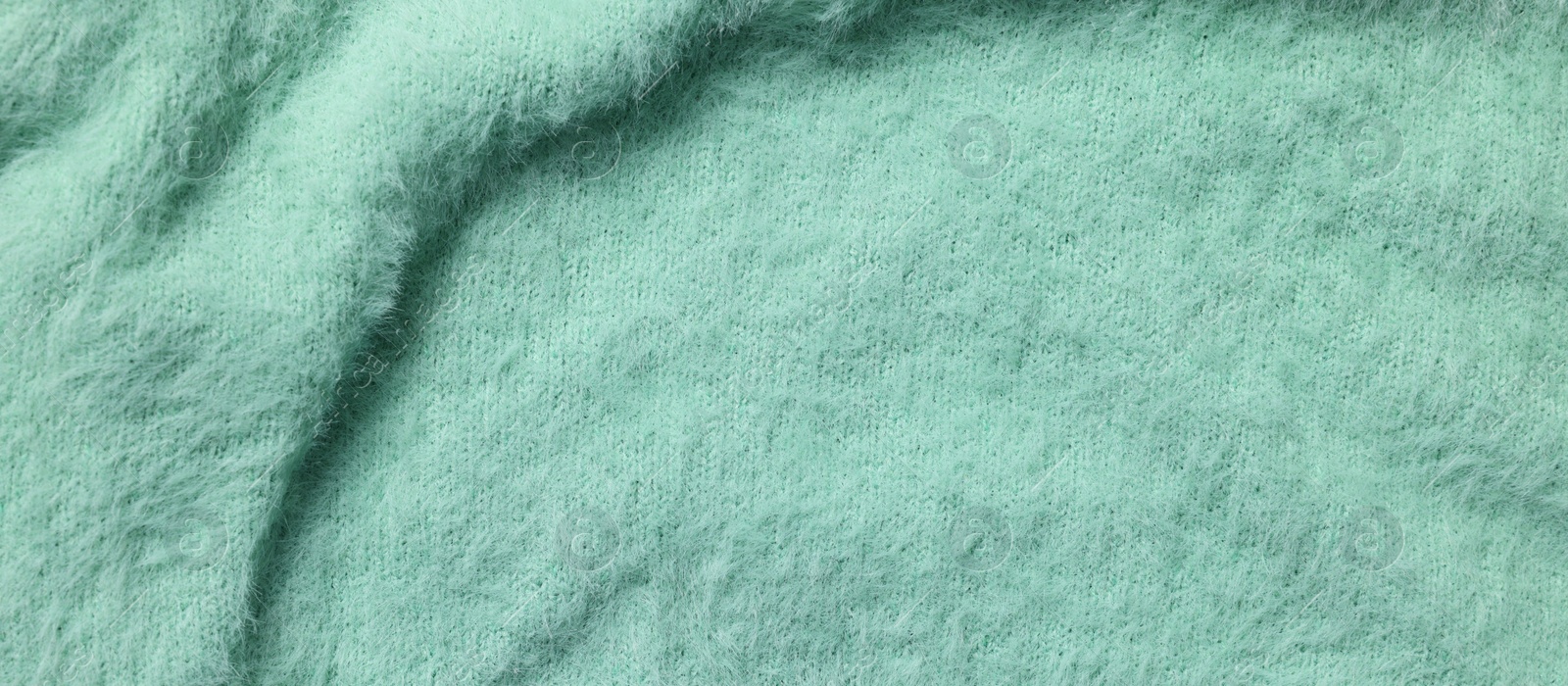 Photo of Texture of soft turquoise fabric as background, top view