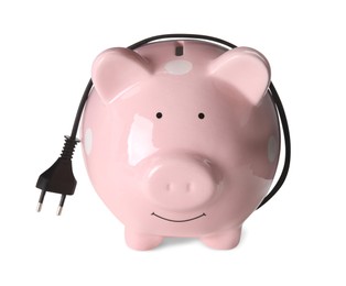 Photo of Piggy bank with power plug on white background. Energy saving concept