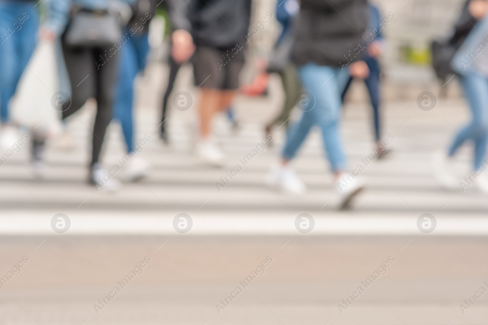 Photo of People crossing street outdoors, closeup. Blurred view