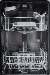 Open clean empty dishwasher, closeup. Home appliance