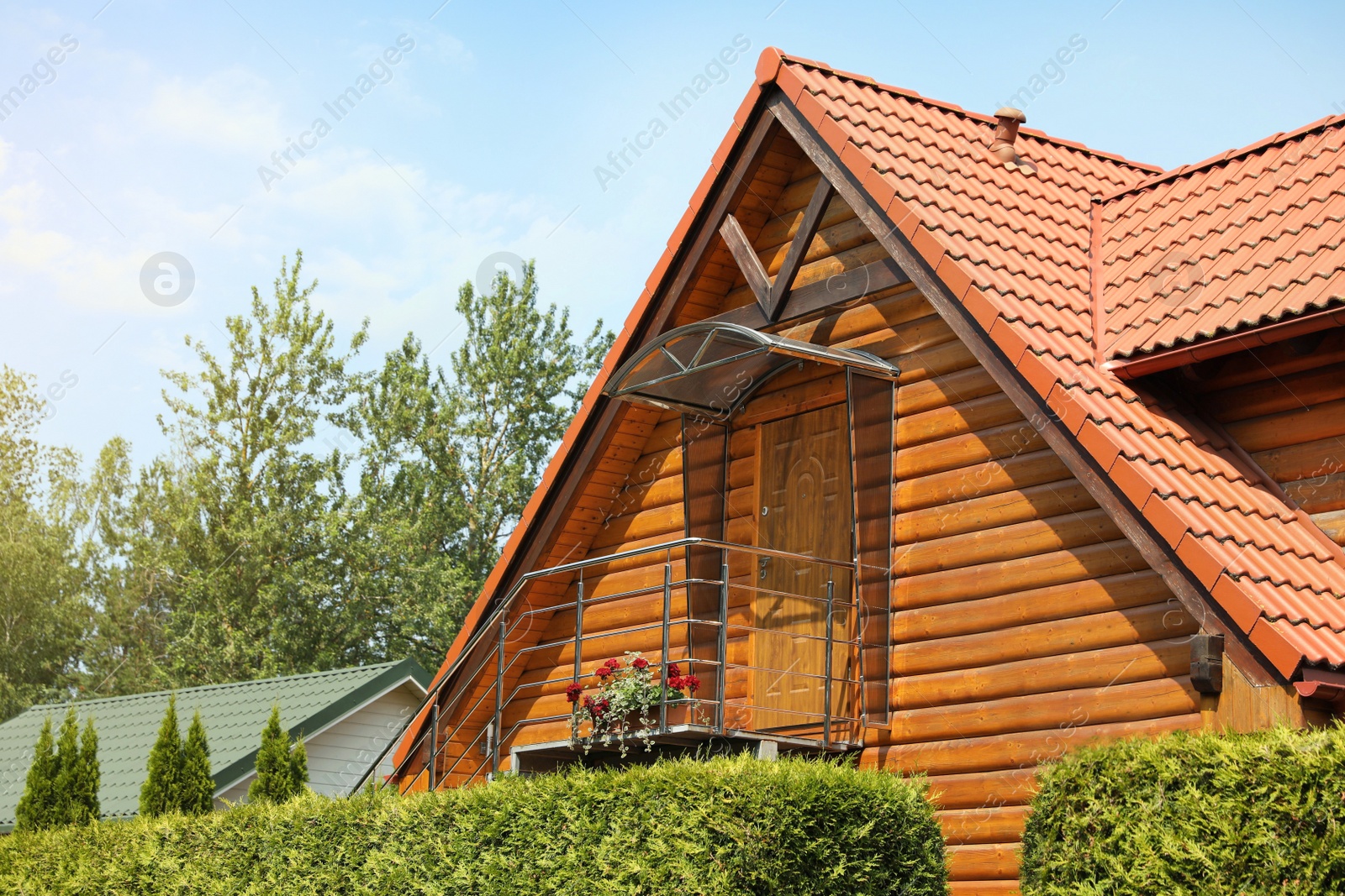 Photo of View of wooden house porch with flowers