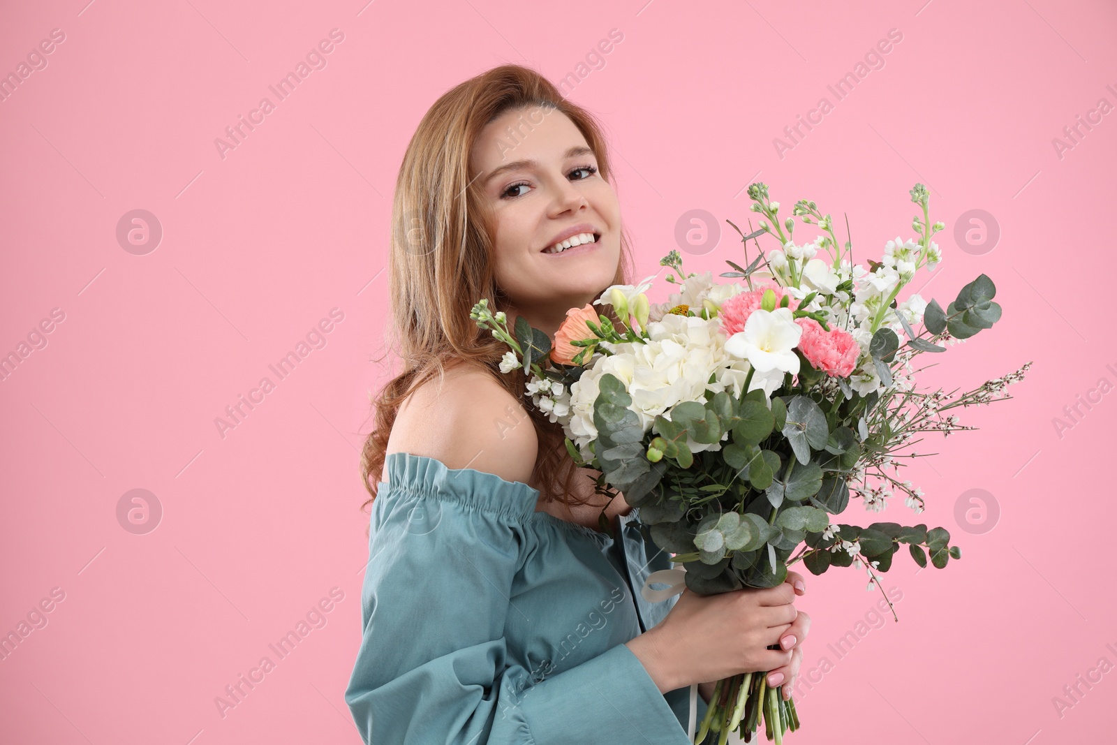 Photo of Beautiful woman with bouquet of flowers on pink background