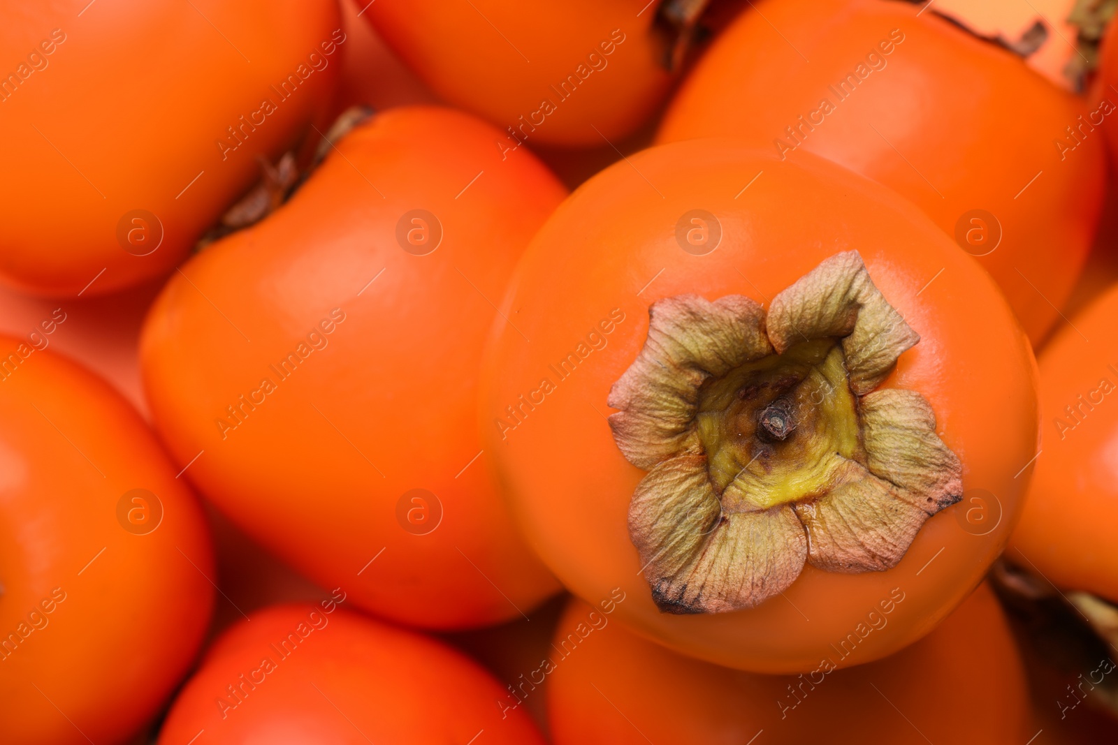 Photo of Delicious ripe juicy persimmons as background, closeup