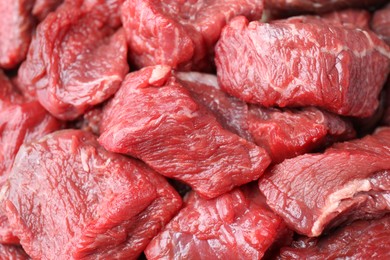 Photo of Pieces of raw beef meat as background, closeup