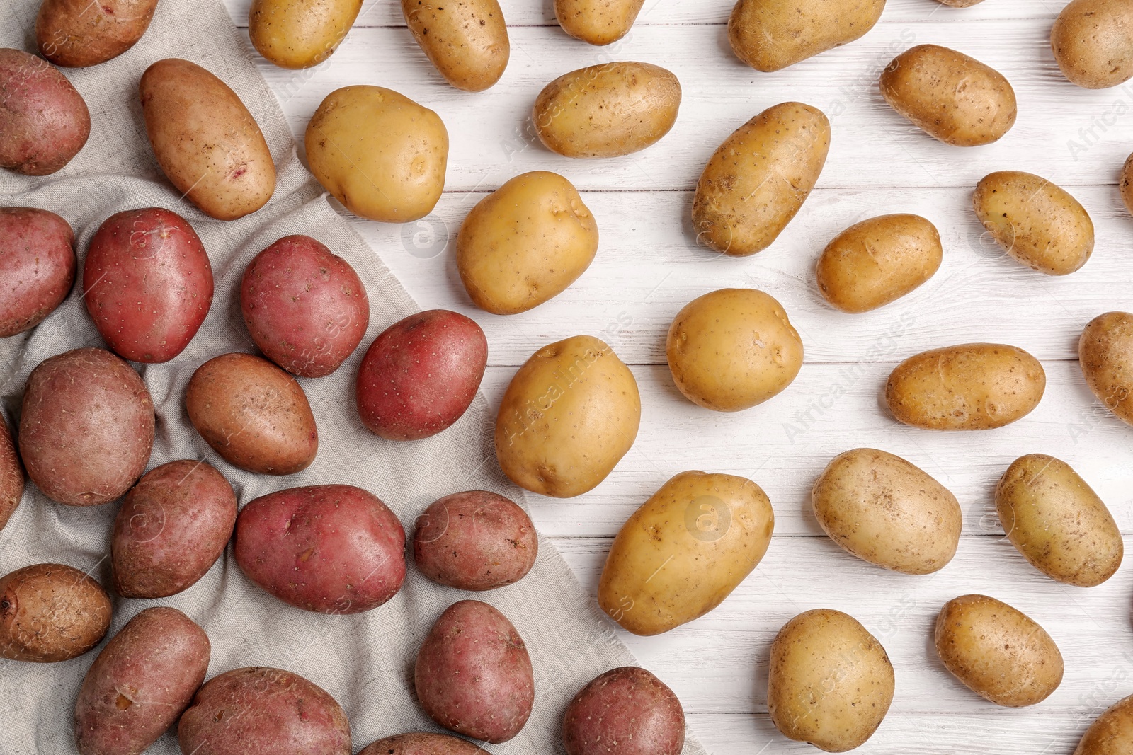 Photo of Flat lay composition with fresh organic potatoes on wooden background