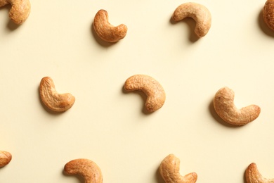 Photo of Tasty cashew nuts on light background, flat lay