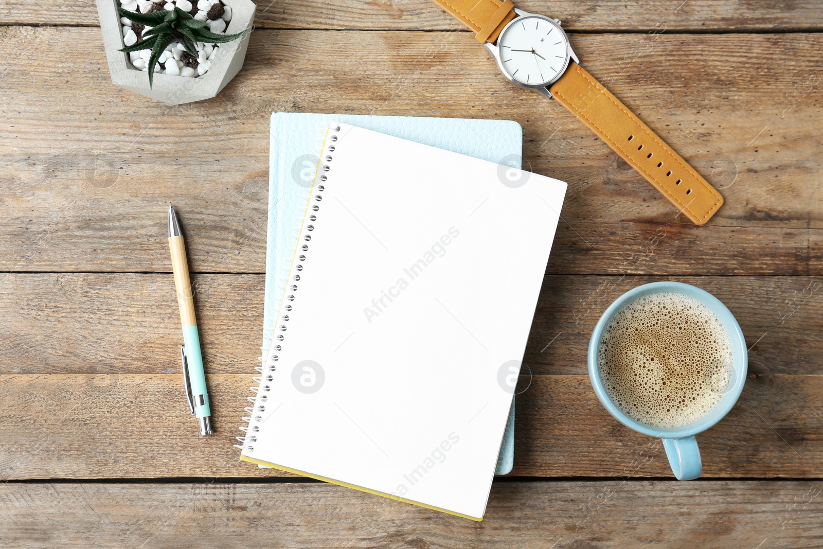 Photo of Flat lay composition with office stationery and cup of coffee on wooden table. Space for design