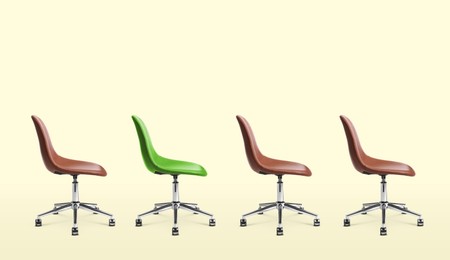 Vacant position. Green office chair among brown ones on beige background, banner design