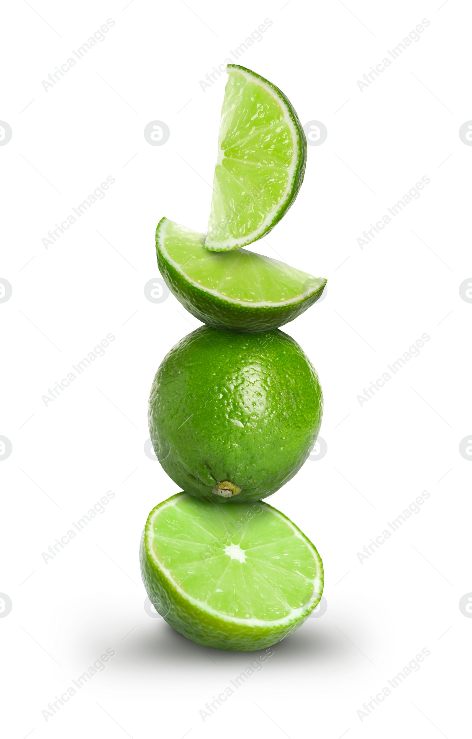 Image of Stacked whole and cut limes on white background