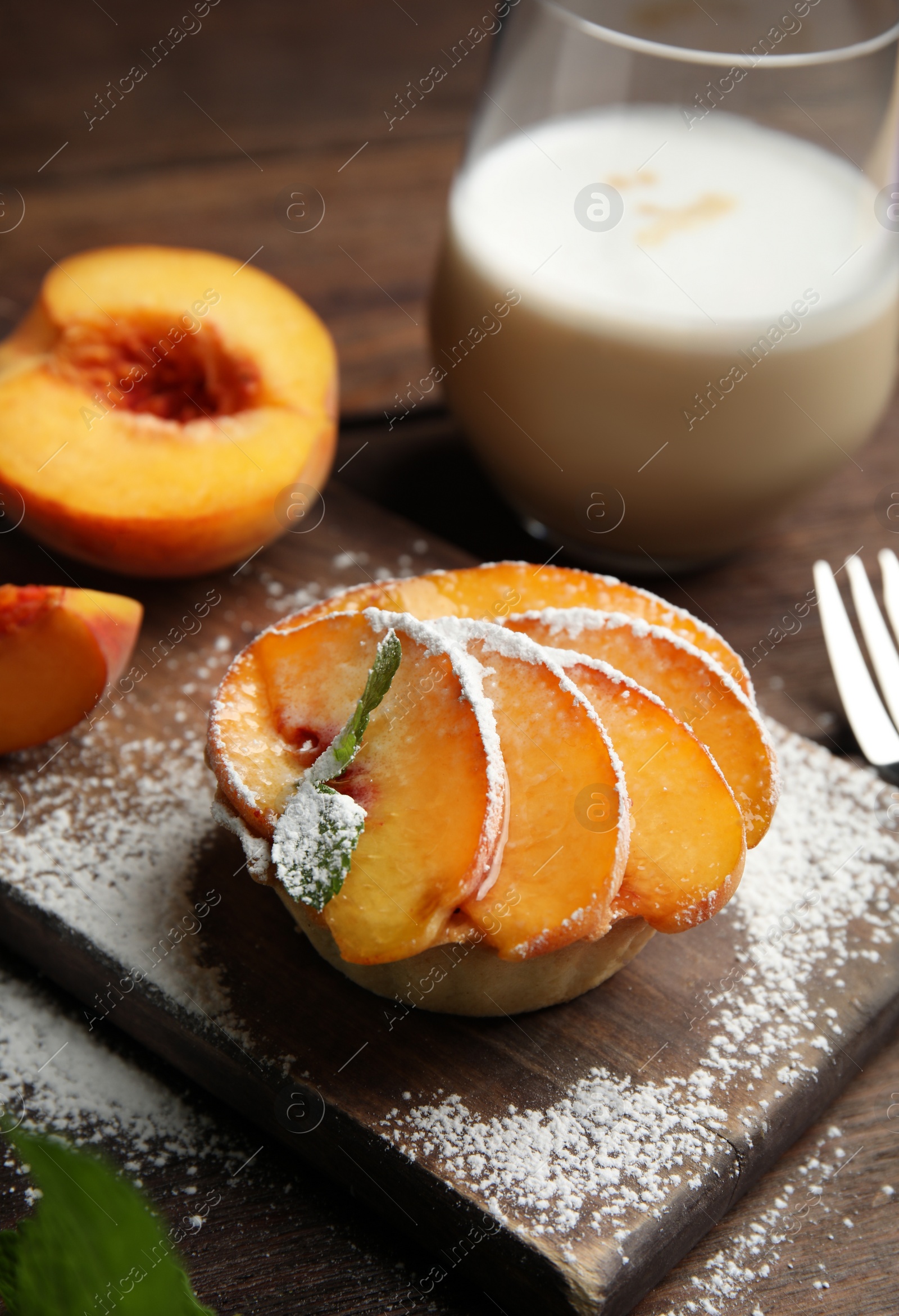Photo of Delicious peach dessert served on wooden table